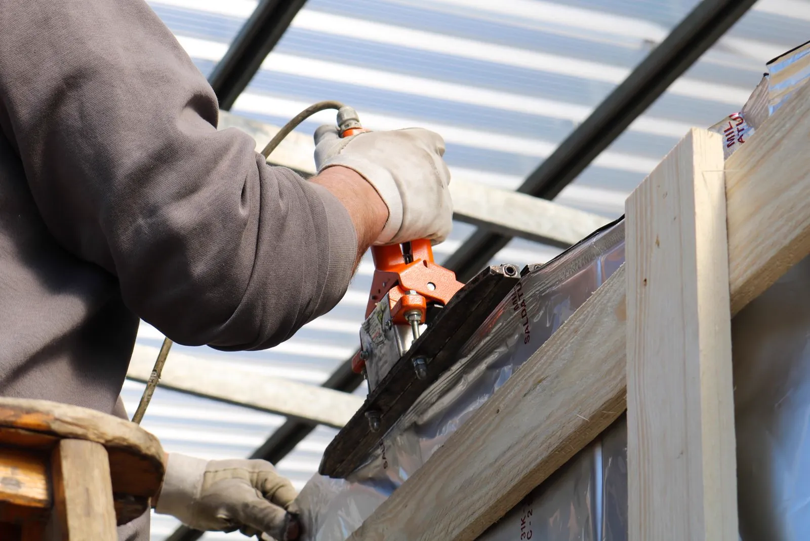 Contractor installing framing and sheathing on a building project